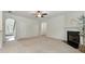 Large living room featuring neutral paint, fireplace, open floor plan, arched doorways, and carpet flooring at 2445 Whitehead Place Dr, Suwanee, GA 30024