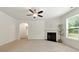 Bright living room featuring a fireplace, neutral carpeting, and view to an en-suite bathroom at 2445 Whitehead Place Dr, Suwanee, GA 30024