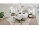 Spacious primary bedroom featuring a ceiling fan, a tray ceiling, large windows and an ensuite bathroom at 2445 Whitehead Place Dr, Suwanee, GA 30024