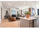 Open-concept kitchen and living area with modern decor, a fireplace, and plenty of natural light at 4034 Dantry Ln, Buford, GA 30519