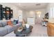 Upstairs loft area featuring a gray couch, coffee table, decorative display shelving and a work area at 4034 Dantry Ln, Buford, GA 30519