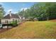 Expansive backyard featuring a well-manicured lawn, swimming pool, and a backdrop of lush, mature trees at 434 Westlake Nw Dr, Marietta, GA 30064