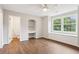 Bright bedroom with hardwood floors, ceiling fan, built-in desk, and large windows at 434 Westlake Nw Dr, Marietta, GA 30064