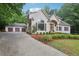 Charming stucco home with a three-car garage and meticulously maintained landscaping at 434 Westlake Nw Dr, Marietta, GA 30064