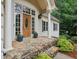 Inviting front porch features stone steps, classic columns, and a wooden front door at 434 Westlake Nw Dr, Marietta, GA 30064