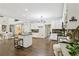 Bright open kitchen features an island, dark countertops, white cabinets, and stainless steel appliances at 434 Westlake Nw Dr, Marietta, GA 30064