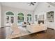 Bright living room with three arched windows, a fireplace, and built-in bookshelves at 434 Westlake Nw Dr, Marietta, GA 30064