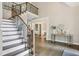 Elegant staircase featuring hardwood steps, iron railings, and a view of the open foyer at 434 Westlake Nw Dr, Marietta, GA 30064