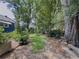 Picturesque backyard with established landscaping, blue siding, mature trees, and a tranquil setting at 5130 Dearing St, Covington, GA 30014