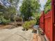 Backyard patio with brick accents, wood storage, plants, metal table, and fenced yard at 5130 Dearing St, Covington, GA 30014