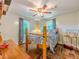Bedroom featuring natural light, a ceiling fan and a patterned bedspread at 5130 Dearing St, Covington, GA 30014