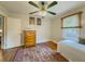 Bright bedroom featuring hardwood floors, a ceiling fan and natural light from a large window at 5130 Dearing St, Covington, GA 30014