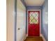 View of a red front door with leaded glass and light blue wall at 5130 Dearing St, Covington, GA 30014