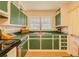 Cozy kitchen with painted cabinets, tile countertops, and stainless steel range at 5130 Dearing St, Covington, GA 30014