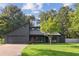 Contemporary home featuring a modern design, dark wood facade, manicured lawn, and attached two-car garage at 600 Applewood Nw Ln, Marietta, GA 30064