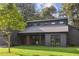 Striking modern home with dark wood siding, a well-manicured lawn, and stylish windows under a cloudy sky at 600 Applewood Nw Ln, Marietta, GA 30064