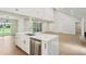 Open kitchen with island, stainless steel appliances, and seamless flow into living space for modern living at 600 Applewood Nw Ln, Marietta, GA 30064