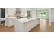 Modern kitchen with white cabinetry, stainless steel appliances, a quartz island, and hardwood floors at 600 Applewood Nw Ln, Marietta, GA 30064