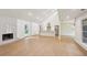 Bright and modern living space featuring wood floors, a fireplace, and an open floor plan connected to the kitchen at 600 Applewood Nw Ln, Marietta, GA 30064