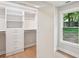 Bright walk-in closet features custom shelving, drawers, and a window for natural light, enhancing organization and appeal at 600 Applewood Nw Ln, Marietta, GA 30064