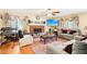 Spacious living room with fireplace, hardwood floors, ceiling fan, and large windows at 179 Parkside Dr, Stockbridge, GA 30281