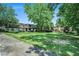 View of the complex showing the manicured lawn and mature trees. An inviting place to call home at 50 Le Parc Fontaine, Lithonia, GA 30038