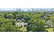 Aerial view of homes with mature trees and the city skyline in the distance on a bright sunny day at 524 Paines Nw Ave, Atlanta, GA 30318