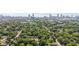 An aerial perspective of a tree-lined neighborhood with the Atlanta skyline in the distance on a clear, sunny day at 524 Paines Nw Ave, Atlanta, GA 30318