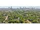 Overhead aerial shot of homes surrounded by mature trees with a view of downtown Atlanta and the stadium at 524 Paines Nw Ave, Atlanta, GA 30318