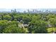 Scenic aerial view of homes nestled among lush trees with Atlanta skyline and Mercedes-Benz Stadium in the background at 524 Paines Nw Ave, Atlanta, GA 30318