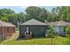 Well-maintained backyard with green grass, a small tree, and a charming home exterior at 524 Paines Nw Ave, Atlanta, GA 30318
