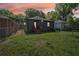 A spacious backyard featuring lush green grass, a wooden deck, and a charming exterior, perfect for outdoor relaxation at 524 Paines Nw Ave, Atlanta, GA 30318