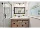 Stylish bathroom showcasing a wood vanity, glass shower, modern fixtures, and natural light at 524 Paines Nw Ave, Atlanta, GA 30318