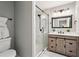 Bathroom boasts a glass shower, framed mirror, stylish light fixture, and rustic vanity at 524 Paines Nw Ave, Atlanta, GA 30318