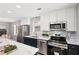 Stylish kitchen features stainless steel appliances, marble counters, and navy and white cabinets at 524 Paines Nw Ave, Atlanta, GA 30318