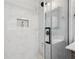 Luxurious shower with white marble tiling, a glass door, and sleek fixtures at 524 Paines Nw Ave, Atlanta, GA 30318