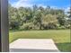 Spacious backyard with a large patio and lush green trees offers privacy and tranquility at 1128 E Shoreview Rd, Mcdonough, GA 30253