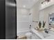 Bathroom with white vanity, double sinks, and shower-tub combination with neutral paint at 1128 E Shoreview Rd, Mcdonough, GA 30253