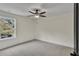 Neutral bedroom featuring a ceiling fan, plush carpet, and a large window with natural light at 1128 E Shoreview Rd, Mcdonough, GA 30253