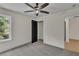 Neutral bedroom featuring a closet, plush carpet, and a large window with natural light at 1128 E Shoreview Rd, Mcdonough, GA 30253