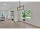 Bright dining area with hardwood floors, modern lighting fixture, and large windows overlooking backyard at 1128 E Shoreview Rd, Mcdonough, GA 30253