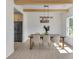 Light-filled dining room with wood beams, wainscoting, modern lighting, and stainless steel appliances in view at 1128 E Shoreview Rd, Mcdonough, GA 30253
