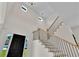 Bright two-story foyer with black door, hardwood staircase, and clerestory windows at 1128 E Shoreview Rd, Mcdonough, GA 30253