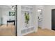 Hallway with drop zone, hardwood flooring, and neutral paint with doorway to an office at 1128 E Shoreview Rd, Mcdonough, GA 30253