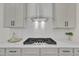 Stylish kitchen with sleek countertops, stainless steel range hood, gas cooktop, and ample storage space at 1128 E Shoreview Rd, Mcdonough, GA 30253