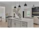 Well-designed open concept kitchen island with modern fixtures, connecting seamlessly to the living and dining areas at 1128 E Shoreview Rd, Mcdonough, GA 30253