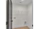 A convenient laundry room features a wire shelf for storage and easy access to hook-ups at 1128 E Shoreview Rd, Mcdonough, GA 30253