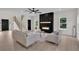 Bright living room with fireplace, white sofas, and modern design elements at 1128 E Shoreview Rd, Mcdonough, GA 30253