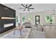 Spacious open-concept living room features fireplace, white sofas, modern decor, and natural light at 1128 E Shoreview Rd, Mcdonough, GA 30253