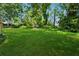 Expansive green backyard with mature trees, offering a serene outdoor space at 3835 Thornhill Sw Dr, Lilburn, GA 30047